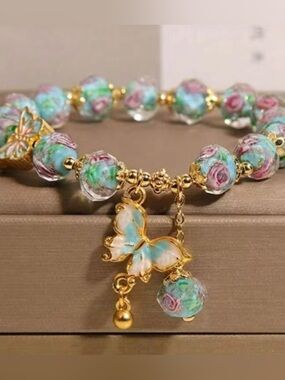 NWOT Gold Butterfly Charm Bracelet with Blue-Green Floral Beads